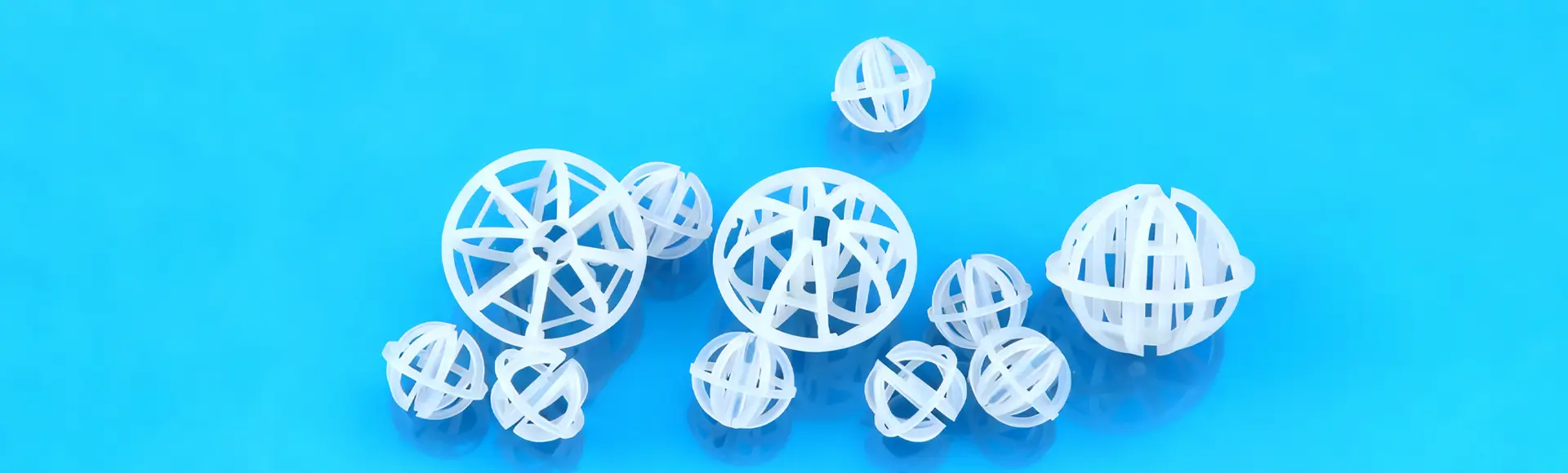 Three large and several small plastic tri-pack rings lying on the black glass.