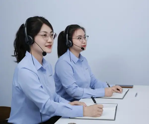 Two specialists in work attire taking notes