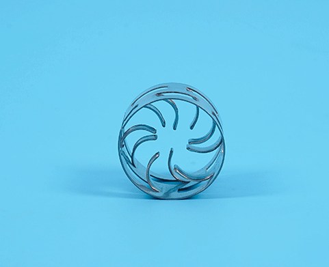 A 360-degree view of a metal Pall ring against a blue background