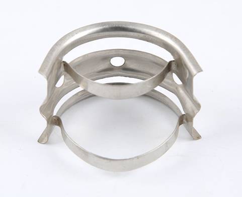 A metal nutter ring which on the white background shows the reverse side of it.